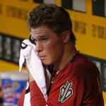 Arizona Diamondbacks starting pitcher Chase Anderson wipes his face in the dugout after being removed from a baseball game against the Pittsburgh Pirates during the fourth inning in Pittsburgh, Wednesday, July 2, 2014. (AP Photo/Gene J. Puskar)
