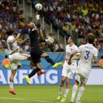 United States' goalkeeper Tim Howard leaps in between his teammates to clear the ball during the World Cup round of 16 soccer match between Belgium and the USA at the Arena Fonte Nova in Salvador, Brazil, Tuesday, July 1, 2014. (AP Photo/Natacha Pisarenko)