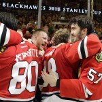 Members of the Chicago Blackhawks celebrate after defeating the Tampa Bay Lightning in Game 6 of the NHL hockey Stanley Cup Final series on Monday, June 15, 2015, in Chicago. The Blackhawks defeated the Lightning 2-0 to win the series 4-2. (AP Photo/Nam Y. Huh)
