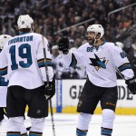 San Jose Sharks right wing Brent Burns, right, celebrates his goal with teammates defenseman Dan Boyle, left, and center Joe Thornton during the first period in Game 3 of an NHL hockey first-round playoff series , Tuesday, April 22, 2014, in Los Angeles. (AP Photo/Mark J. Terrill)