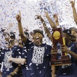 Connecticut celebrates with the championship trophy after beating Kentucky 60-54 at the NCAA Final Four tournament college basketball championship game Monday, April 7, 2014, in Arlington, Texas. (AP Photo/David J. Phillip)