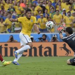 Brazil's Hulk, center, has a shot saved by Colombia's goalkeeper David Ospina during the World Cup quarterfinal soccer match between Brazil and Colombia at the Arena Castelao in Fortaleza, Brazil, Friday, July 4, 2014. (AP Photo/Manu Fernandez)