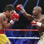 Floyd Mayweather Jr., right, throws a right against Manny Pacquiao, from the Philippines, during their welterweight title fight on Saturday, May 2, 2015 in Las Vegas. (AP Photo/John Locher)