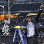 Connecticut head coach Kevin Ollie cuts down the net after his team's 60-54 victory over Kentucky in the NCAA Final Four tournament college basketball championship game Monday, April 7, 2014, in Arlington, Texas. (AP Photo/David J. Phillip)