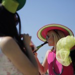 Angela Morano has a drink before the 141th running of the Kentucky Oaks horse race at Churchill Downs Friday, May 1, 2015, in Louisville, Ky. (AP Photo/Jeff Roberson)