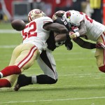 Arizona Cardinals running back Andre Ellington (38) is unable to hold onto the ball as San Francisco 49ers inside linebacker Patrick Willis (52) and Jimmie Ward (25) defend during the first half of an NFL football game, Sunday, Sept. 21, 2014, in Glendale, Ariz. (AP Photo/Ross D. Franklin)