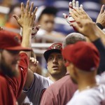  Arizona Diamondbacks' Cliff Pennington celebrates in the dugout after hitting a home run during the first inning of a baseball game in Miami against the Miami Marlins, Friday, Aug. 15, 2014. (AP Photo/J Pat Carter)