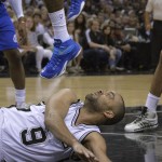 San Antonio Spurs' Tony Parker (9) eyes the feet of Los Angeles Clippers' DeAndre Jordan after he slipped while driving to the basket during the second half of Game 6 in an NBA basketball first-round playoff series, Thursday, April 30, 2015, in San Antonio. Los Angeles won 102-96. (AP Photo/Darren Abate)