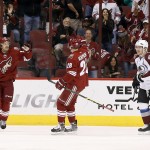 Arizona Coyotes' Antoine Vermette, left, celebrates his goal with teammate Lauri Korpikoski (28), of Finland, as Colorado Avalanche's Gabriel Landeskog (92), of Sweden, skates by during the first period of an NHL hockey game Tuesday, Nov. 25, 2014, in Glendale, Ariz. (AP Photo/Ross D. Franklin)
