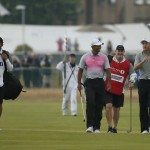 Tiger Woods of the US, center, and Jordan Spieth of the US, right, talk together as they walk along the 18th fairway with during the third day of the British Open Golf championship at the Royal Liverpool golf club, Hoylake, England, Saturday July 19, 2014. (AP Photo/Alastair Grant)