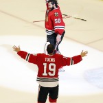 Chicago Blackhawks' goalie Corey Crawford, top, and Jonathan Toews celebrate after defeating the Tampa Bay Lightning in Game 6 of the NHL hockey Stanley Cup Final series on Monday, June 15, 2015, in Chicago. The Blackhawks defeated the Lightning 2-0 to win the series 4-2. (AP Photo/Charles Rex Arbogast)
