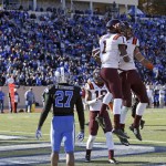 Virginia Tech's Isaiah Ford (1) and Bucky Hodges celebrate Hodges' touchdown as Duke's DeVon Edwards (27) watches during the second half of an NCAA college football game in Durham, N.C., Saturday, Nov. 15, 2014. Virginia Tech won 17-16. (AP Photo/Gerry Broome)