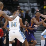 Phoenix Suns guard Brandon Knight looks to pass the ball to guard P.J. Tucker, left, as Denver Nuggets guard Gary Harris, second from left, and forward Danilo Gallinari, of Italy, defend during the fourth quarter of an NBA basketball game Wednesday, Feb. 25, 2015, in Denver. The Suns won 110-96. (AP Photo/David Zalubowski)