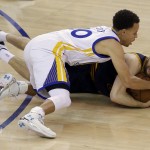 Cleveland Cavaliers guard Matthew Dellavedova, bottom, hangs on to the ball under Golden State Warriors guard Stephen Curry during the first half of Game 5 of basketball's NBA Finals in Oakland, Calif., Sunday, June 14, 2015. (AP Photo/Eric Risberg)
