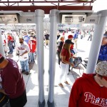 Fans pass through metal detectors ahead of the Philadelphia Phillies opening day baseball game against Boston Red Sox on Monday, April 6, 2015, in Philadelphia. Citizens Bank Park has installed walk-through metal detectors to comply with Major League Baseball's new rule that all spectators be scanned before entering its stadiums. (AP Photo/Matt Rourke)
