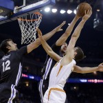 Phoenix Suns' Goran Dragic, right, has his shot blocked by Golden State Warriors' Klay Thompson, center, as Andrew Bogut (12) assists during the first half of an NBA basketball game Saturday, Jan. 31, 2015, in Oakland, Calif. (AP Photo/Marcio Jose Sanchez)