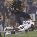 Arizona State running back Kalen Ballage (9) is hit by UCLA defensive back Fabian Moreau (10) during the first half of an NCAA college football game, Thursday, Sept. 25, 2014, in Tempe, Ariz. (AP Photo/Rick Scuteri)