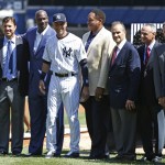  New York Yankees' Derek Jeter, center, wearing his Yankee uniform, poses with former teammates and friends, including shortstop Cal Ripken, far left, Michael Jordan, just left of Jeter, Joe Torre, Mariano Rivera, Hideki Matsui, and Reggie Jackson, in a pregame ceremony honoring the Yankees captain, who is retiring at the end of the season, on Derek Jeter Day at Yankee Stadium in New York, Sunday, Sept. 7, 2014. (AP Photo/Kathy Willens)