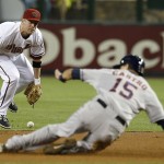  Arizona Diamondbacks' Aaron Hill, left, drops the ball for an error as Houston Astros' Jason Castro (15) slides safely into second base during the first inning of a baseball game on Monday, June 9, 2014, in Phoenix. (AP Photo/Ross D. Franklin)