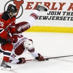  Phoenix Coyotes defenseman Oliver Ekman-Larsson, right, of Sweden, falls to the ice while defending against New Jersey Devils' Tuomo Ruutu, of Finland, during overtime of an NHL hockey game, Thursday, March 27, 2014, in Newark, N.J. The Coyotes won 3-2 in a shootout. (AP Photo/Julio Cortez)