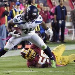 Seattle Seahawks running back Marshawn Lynch (24) breaks a tackle by Washington Redskins inside linebacker Perry Riley (56) on his way to a touchdown during the second half of an NFL football game in Landover, Md., Monday, Oct. 6, 2014. (AP Photo/Nick Wass)