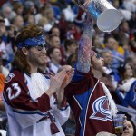 Colorado Avalanche fans hold a foil Stanley Cup before the start of Game 1 of an NHL hockey first-round playoff series against the Minnesota Wild, Thursday, April 17, 2014, in Denver. (AP Photo/Jack Dempsey)
