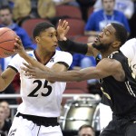 Purdue's Rapheal Davis, right, guards Cincinnati's Kevin Johnson during the second half of an NCAA tournament second round college basketball game in Louisville, Ky., Thursday, March 19, 2015. Cincinnati won 66-65 in overtime. (AP Photo/Timothy D. Easley)
