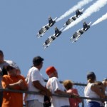 Fans watch as four L-39 Albatros high-performance jet trainer aircraft flown by the Black Diamond Jet Team, a civilian-owned aerobatic jet team perform a fly-over during the National Anthem before the start of the 98th running of the Indianapolis 500 IndyCar auto race at the Indianapolis Motor Speedway in Indianapolis, Sunday, May 25, 2014. (AP Photo/Tom Strattman)