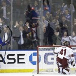 New York Rangers' Chris Kreider (20) celebrates his goal with teammate Kevin Hayes (13) as Arizona Coyotes goalie Mike Smith (41) gets up during the first period of an NHL hockey game Thursday, Feb. 26, 2015, in New York. (AP Photo/Frank Franklin I