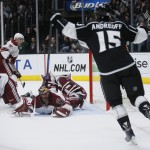 Los Angeles Kings left wing Andy Andreoff celebrates scoring past Arizona Coyotes defenseman Klas Dahlbeck, left, defenseman John Moore, second left, and goalie Mike Smith, center, during the second period of an NHL hockey game, Monday, March 16, 2015, in Los Angeles. (AP Photo/Danny Moloshok)