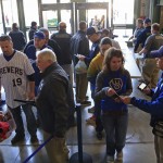 Fans go through security before entering Miller Park before the start of an opening day baseball game between the Milwaukee Brewers and the Colorado Rockies Monday, April 6, 2015 in Milwaukee. (AP Photo/Darren Hauck)