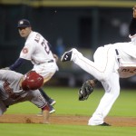 Houston Astros shortstop Jonathan Villar, right, collides with Arizona Diamondbacks' Didi Gregorius on a successful steal during the third inning of of a baseball game on Thursday, June 12, 2014, in Houston. Gregorius was shaken up on the play but remained in the game. (AP Photo/Patric Schneider)