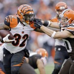 Cincinnati Bengals running back Jeremy Hill (32) breaks a tackle by Cleveland Browns defensive back Jim Leonhard on his way to a 16-yard touchdown in the second quarter of an NFL football game Sunday, Dec. 14, 2014, in Cleveland. (AP Photo/Tony Dejak)