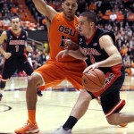 Arizona guard T.J. McConnell, right. drives on Oregon State guard Malcolm Duvivier during the first half of an NCAA college basketball game in Corvallis, Ore., Sunday, Jan. 11, 2015. (AP Photo/Don Ryan)
