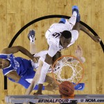 Kentucky guard Andrew Harrison, left, shoots over Connecticut's Niels Giffey, center, and Amida Brimah during the first half of the NCAA Final Four tournament college basketball championship game Monday, April 7, 2014, in Arlington, Texas. (AP Photo/David J. Phillip)
