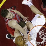 Cleveland Cavaliers center Timofey Mozgov, bottom, fights for a rebound against Chicago Bulls forward Pau Gasol during the first half of Game 1 in a second-round NBA basketball playoff series Monday, May 4, 2015, in Cleveland. (AP Photo/Tony Dejak)