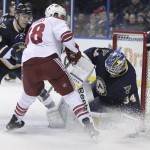 St. Louis Blues goalie Jake Allen (34) makes a save on a shot from Arizona Coyotes' Lucas Lessio (38), as St. Louis Blues' Paul Stastny (26) defends, in the first period of an NHL hockey game, Tuesday, Feb. 10, 2015, in St. Louis. (AP Photo/Tom Gannam)