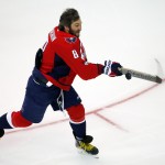 Washington Capitals' Alex Ovechkin, of Team Foligno, swings a goalie stick at an airborne puck in an attempt to score during the breakaway competition at the NHL All-Star hockey skills competition in Columbus, Ohio, Saturday, Jan. 24, 2015. (AP Photo/Gene J. Puskar)
