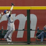 New York Mets' Andrew Brown makes a jumping catch on a fly ball hit by Arizona Diamondbacks' Miguel Montero during the seventh inning of a baseball game on Wednesday, April 16, 2014, in Phoenix. The Mets defeated the Diamondbacks 5-2. (AP Photo/Ross D. Franklin)