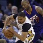 New Orleans Pelicans guard Eric Gordon (10) is fouled by Phoenix Suns forward P.J. Tucker (17) in the first half of an NBA basketball game in New Orleans, Friday, April 10, 2015. (AP Photo/Gerald Herbert)
