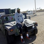 Chicago Bears Martellus Bennett sits on a military vehicle after a practice session at Luke Air Force Base for the NFL Football Pro Bowl Thursday, Jan. 22, 2015, in Glendale, Ariz. (AP Photo/David J. Phillip)