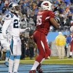 Arizona Cardinals' Darren Fells (85) celebrates after making a touchdown catch against Carolina Panthers' Melvin White (23) in the first half of an NFL wild card playoff football game in Charlotte, N.C., Saturday, Jan. 3, 2015. (AP Photo/Mike McCarn)
