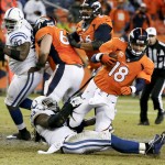 Denver Broncos quarterback Peyton Manning (18) is sacked by Indianapolis Colts outside linebacker Erik Walden (93) during the second half of an NFL divisional playoff football game, Sunday, Jan. 11, 2015, in Denver. The Colts won 24-13 to advance to the AFC Championship game against the New England Patriots. (AP Photo/Jack Dempsey)
