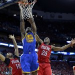 Golden State Warriors forward Harrison Barnes (40) goes to the basket between New Orleans Pelicans guard Eric Gordon (10) and guard Quincy Pondexter (20) during the first half of Game 3 of a first-round NBA basketball playoff series in New Orleans, Thursday, April 23, 2015. (AP Photo/Gerald Herbert)