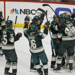 Minnesota Wild left wing Zach Parise (11) and left wing Thomas Vanek (26) pile on goalie Devan Dubnyk, right, as they celebrate after defeating the St. Louis Blues 4-1 in Game 6 of an NHL hockey first-round playoff series in St. Paul, Minn., Sunday, April 26, 2015. (AP Photo/Ann Heisenfelt)
