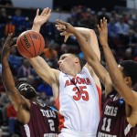 Arizona center Kaleb Tarczewski, center, battles for a rebound against Texas Southern forwards Chris Thomas, left, and Malcolm Riley during the second half in the second round of the NCAA college basketball tournament in Portland, Ore., Thursday, March 19, 2015. Tarczewski scored 13 points as Arizona won 93-72. (AP Photo/Greg Wahl-Stephens)