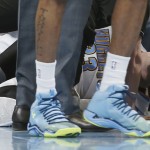 Denver Nuggets center Jusuf Nurkic holds his right leg after being injured while pursuing a rebound against the Phoenix Suns during the fourth quarter of an NBA basketball game Wednesday, Feb. 25, 2015, in Denver. The Suns won 110-96. (AP Photo/David Zalubowski)