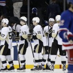  Teammates line up to congratulate Pittsburgh Penguins goalie Marc-Andre Fleury (29), far left, after the Penguins shut out the New York Rangers in their second-round NHL Stanley Cup hockey playoff game at Madison Square Garden in New York, Monday, May 5, 2014. The Penguins lead the series 2-1. New York Rangers center Brian Boyle (22) leaves the ice, far right. (AP Photo/Kathy Willens)
