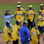 Mo'ne Davis, the first female pitcher in Little League World Series history to pitch a complete-game shutout accompanied by players from the Jackie Robison West Little League team, throws out the ceremonial first pitch before Game 4 of baseball's World Series between the Kansas City Royals and the San Francisco Giants Saturday, Oct. 25, 2014, in San Francisco. (AP Photo/Jeff Chiu)