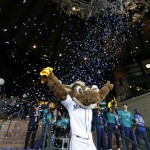 Moose, the Seattle Mariners mascot, welcomes the first fans through the gates as confetti flies behind him before an opening day baseball game between the Seattle Mariners and the Los Angeles Angels, Monday, April 6, 2015, in Seattle. (AP Photo/Ted S. Warren)